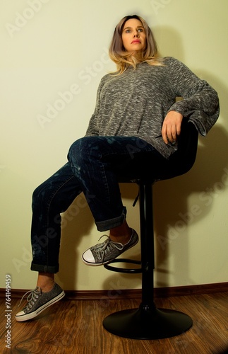 pretty woman sitting on a stool