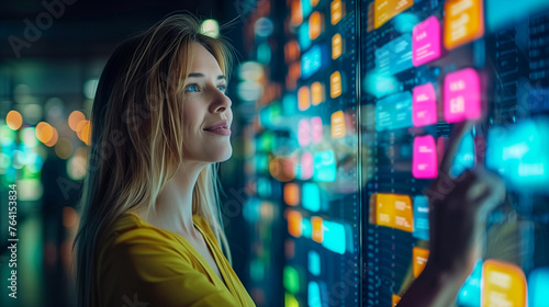 A woman admiring colorful data on screens in a modern technological environment