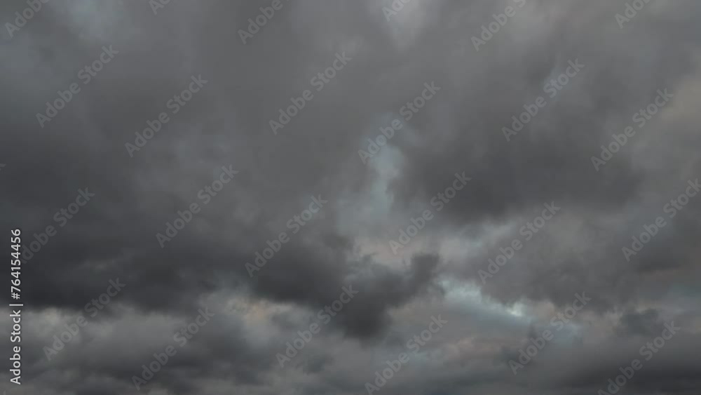 Strange but beautiful landscape of dark clouds moving in different ways at sunset Strange but beautiful landscape of dark clouds moving in different ways at sunset