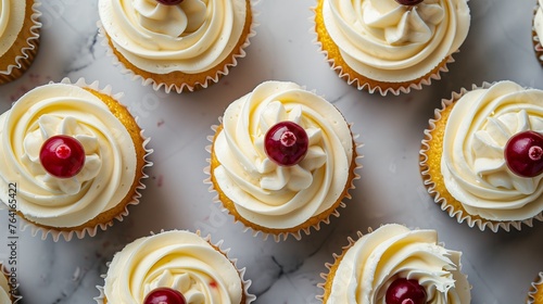 cupcakes from above adorned with piped buttercream cherries and chocolate flakes