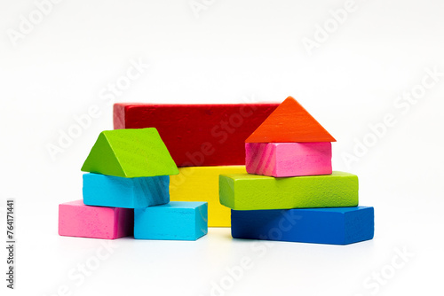 House made of old cubes. Wooden colorful building blocks isolated on white background. Vintage children toys.