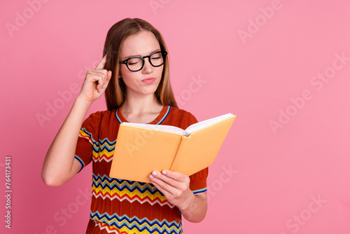 Portrait of minded pensive person read book finger scratch head empty space isolated on pink color background