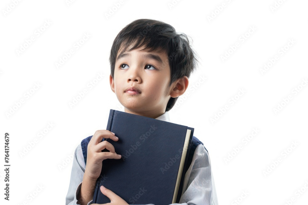 portrait of cute Asian boy student thinking and holding big book isolated on white background portrait of cute Asian boy student thinking and holding big book isolated on white background