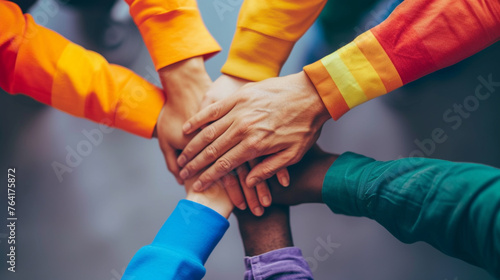 A photo of diverse hands stacked together, symbolizing unity and support in the human rights movement photo