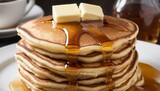Fluffy buttermilk pancakes with butter and maple syrup