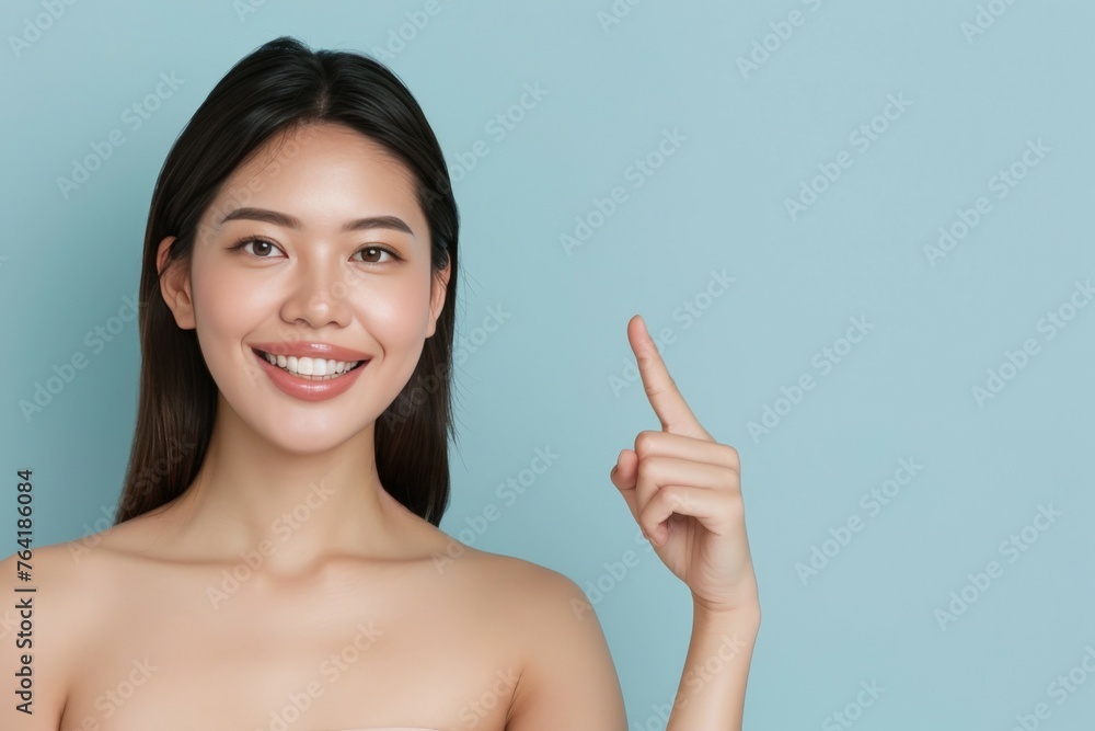 Confident Japanese Woman Pointing Upwards on Light Blue Background. Generative AI. Confident Japanese Woman Pointing Upwards on Light Blue Background. Generative AI.