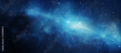 An illustration of a celestial blue galaxy filled with twinkling stars and a luminous light shining prominently at its center