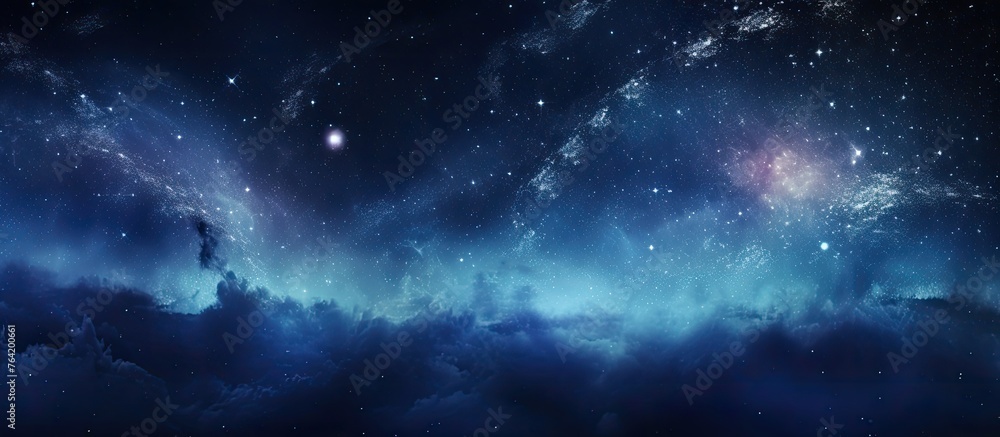 An atmospheric image of a sky filled with stars and clouds in shades of blue and black