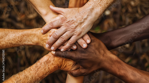 Capture the essence of solidarity with a close-up image of diverse hands clasped together in unity, symbolizing teamwork, collaboration, and strength. photo
