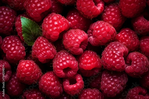 Fresh sweet red raspberries arranged together signifying a healthy diet and nutrition concept