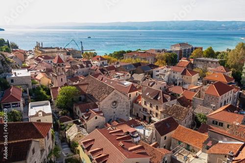 Aerial view of old centre of coastal town Omis in Split-Dalmatia, Croatia, Europe. Majestic coastline of Omis Riviera at Adriatic Sea in Balkans. Summer travel destination. Viewpoint from Peovica fort photo