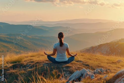 A woman gracefully sits in a yoga position on top of a hill, finding balance and peace in nature, A woman in yoga attire meditating on a hilltop, AI Generated
