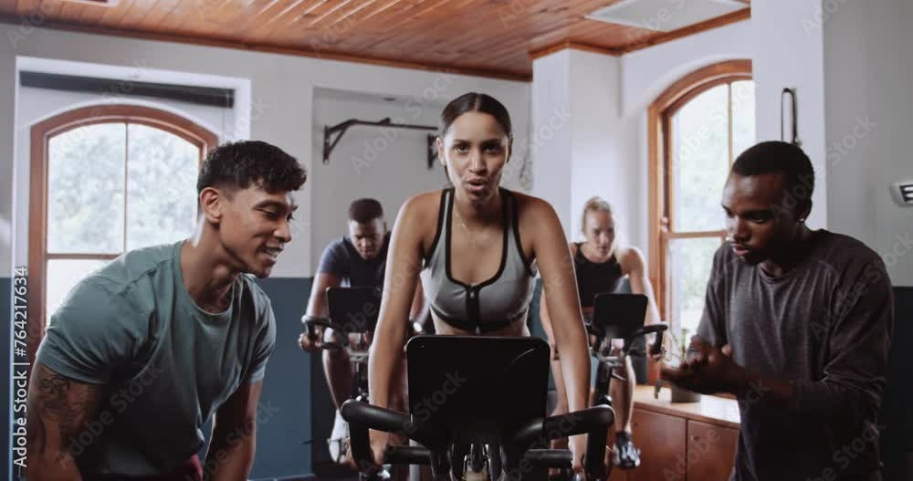 People cycling on exercise bikes in gym room for fun and leisure People cycling on exercise bikes in gym room for fun and leisure