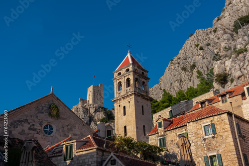 Scenic view of Saint Michael church and Mirabela Fortress (Peovica) in old town of Omis, Split-Dalmatia, South Croatia, Europe. Mediterranean architecture landmark surrounded by steep Dinara mountains