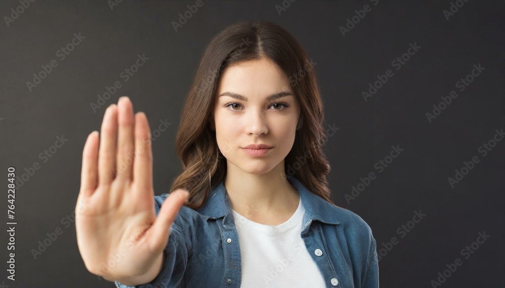 Close up of woman showing stop gesture with hand raising up on black background, young female protesting against domestic violence and abuse, bullying, saying no to gender discrimination Close up of woman showing stop gesture with hand raising up on black background, young female protesting against domestic violence and abuse, bullying, saying no to gender discrimination
