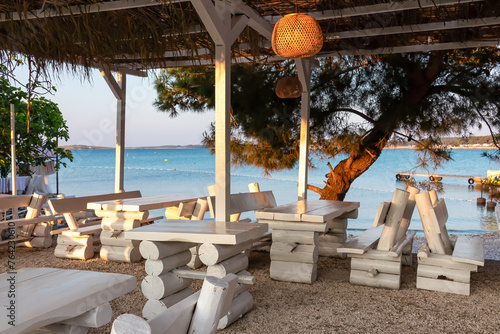 Luxury seaview restaurant on idyllic beach in coastal town Medulin, Istria peninsula, Croatia, Europe. Scenic coastline view of Kvarner Gulf,  Adriatic Mediterranean Sea. Travel destination in summer photo