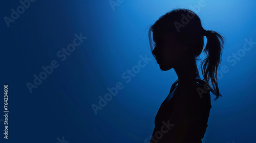silhouette of a girl on a blue background © Taia