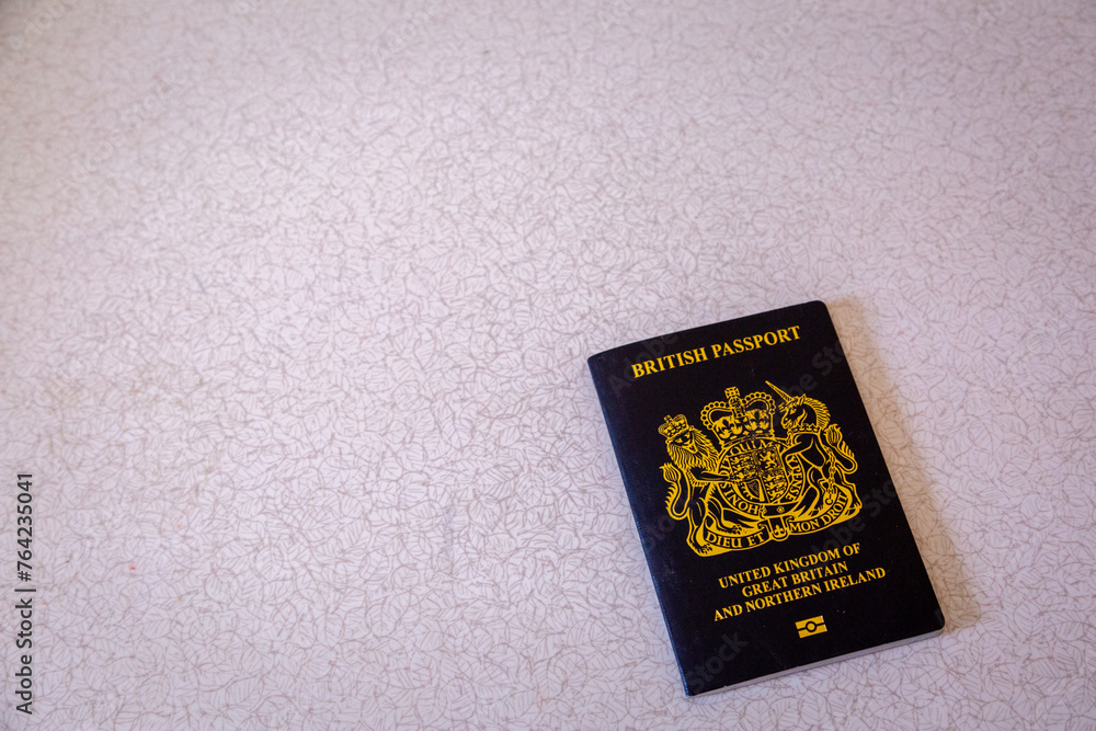 New British passport of post-Brexit blue black UK passport cover with against light background New British passport of post-Brexit blue black UK passport cover with against light background