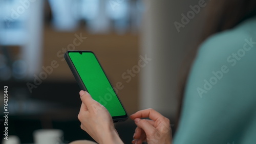User scrolling chroma key smartphone at office closeup. Woman holding device