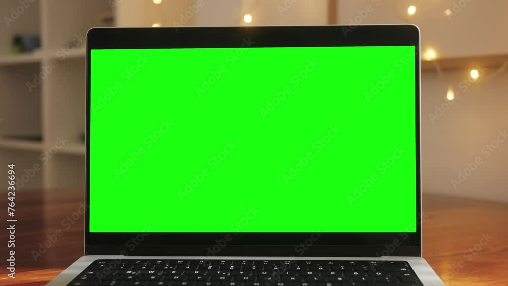 Close up table of distant worker at home. Modern laptop computer with chroma key green screen. Close up table of distant worker at home. Modern laptop computer with chroma key green screen.