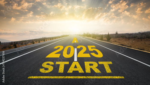 The beginning of the new year 2025. The word 2025 written on the asphalt road at sunrise. The concept of a new anniversary, new plans and goals.