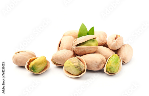 Pistachio nuts with leaves on white backgrounds .