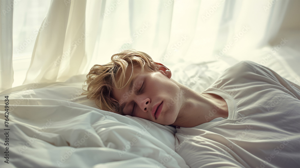 A 30-year-old man sleeps on a white bed. A 30-year-old man sleeps on a white bed.