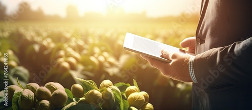 Man holding tablet in field photo