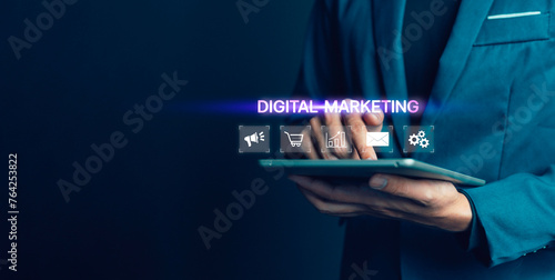 A man is holding a tablet with the words digital marketing on it. Concept of a person using technology to promote a product or service
