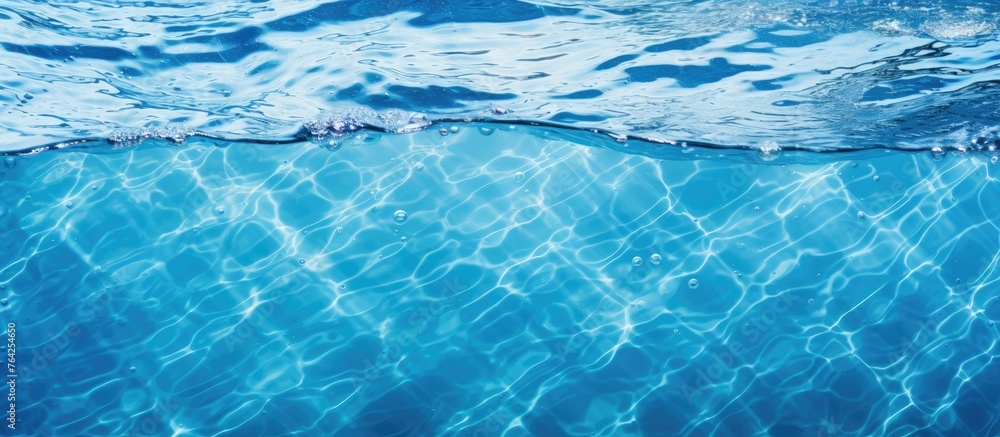 A close up view of the undulating blue waves on the surface of the water