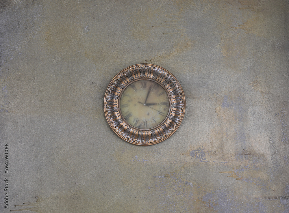 OLD DUSTY CLOCK on a concrete wall