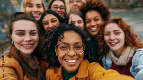 Diverse group of young women taking a selfie together. Friendship and joy concept with place for text