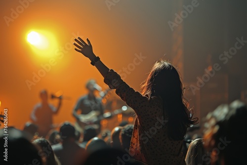 An evocative image capturing the exhilaration and unity of a crowd enjoying a live music performance