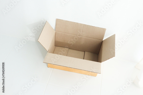 Open cardboard box on white background,delivery unboxing concept. © wanatithan