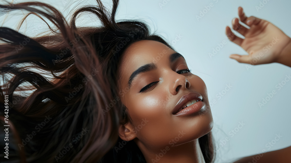 Fototapeta premium Beautiful woman modeling her long, shiny, silky hair