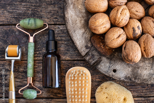 Nut oils with rollers. Beauty care tools on the table. 