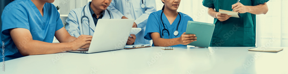 Professional various team of medical working and planning medical treatment at hospital table together. Teamwork lead to successful illness and sickness treatment. Panorama Rigid - obrazy, fototapety, plakaty 