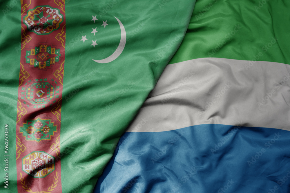big waving national colorful flag of sierra leone and national flag of turkmenistan.