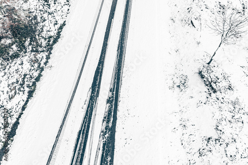 drone aerial view of a road in a snowy landscape, winter time transportation concept © Vic