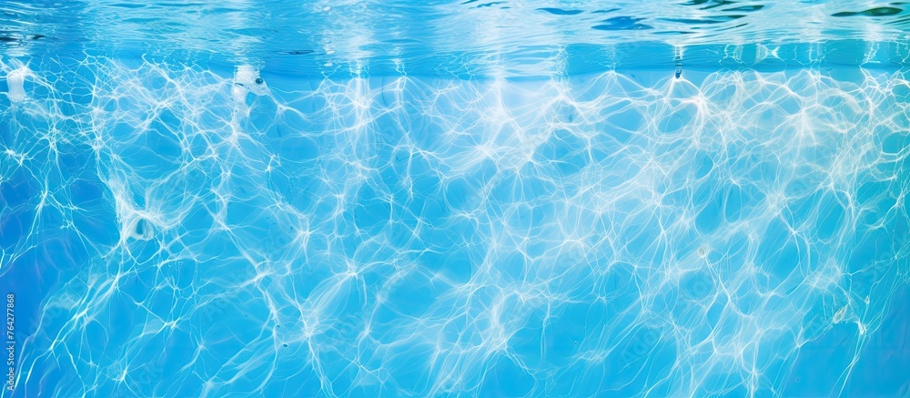 A close-up view of a tranquil pool with crystal-clear water glistening under the warm sunlight