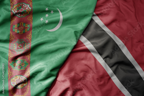 big waving national colorful flag of trinidad and tobago and national flag of turkmenistan.
