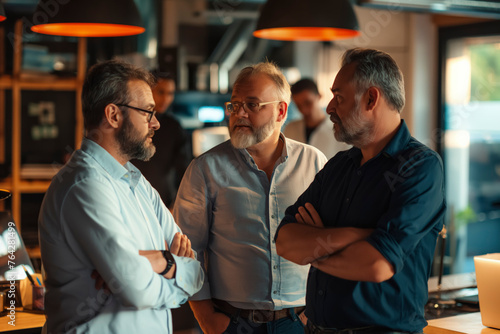Business Corporate Collaboration: Three men are standing in a restaurant, one of them is wearing glasses, Professional Team Strategizing and Brainstorming with Technology in Modern Office Setting © BrightSpace