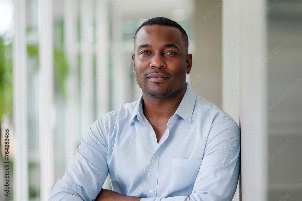 Confident man posing in a blue shirt at modern home Confident man posing in a blue shirt at modern home