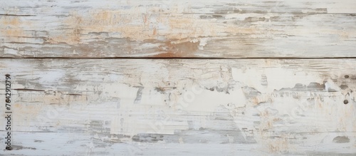 A close up of a white painted wood wall with peeling paint