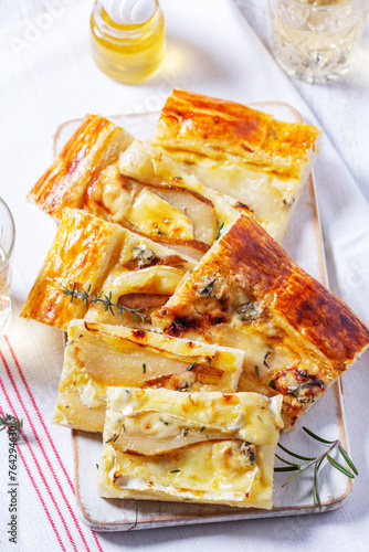 Obraz na płótnie Puff pastry pie with cheese, pears, nuts and honey, served with champagne. w salonie