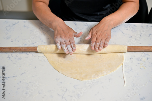 person rolling dough