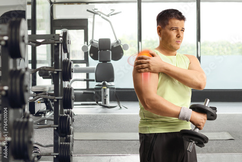 Man with shoulder injury and red inflamed area lifting weights