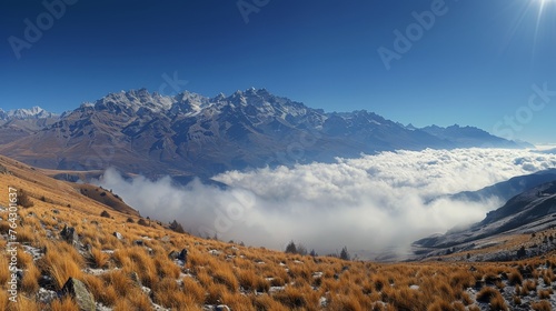 Snow-Covered Mountain Range in Clouds