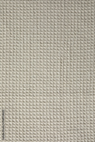 Texture of beige knitted fabric as background, top view