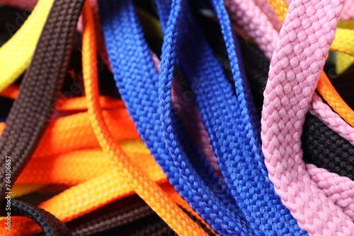 Many colorful shoe laces as background, top view